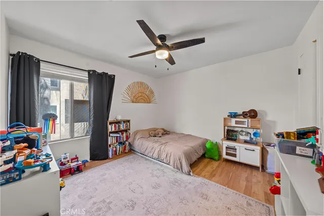 a bedroom with furniture and a book shelf
