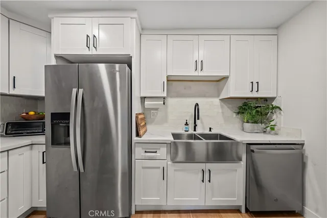a kitchen with kitchen island a sink cabinets and refrigerator