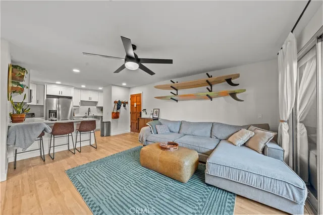 a living room with furniture and a wooden floor