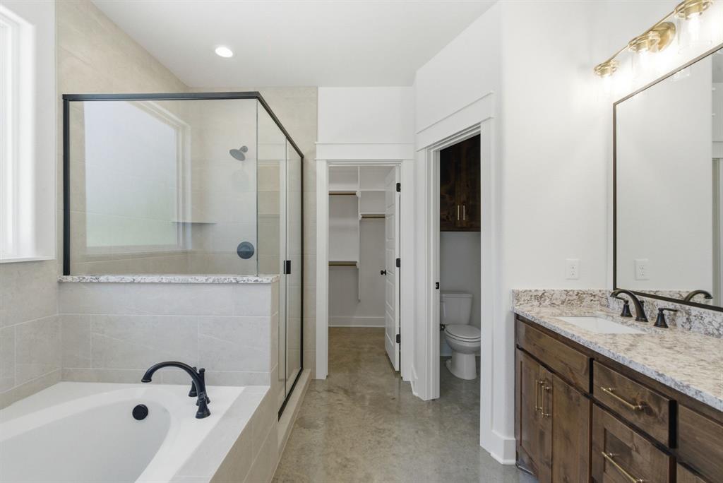 109 Graystone Weatherford, TX 76088 - Photo 13 of 26 a bathroom with a granite countertop sink a mirror a shower and a bathtub