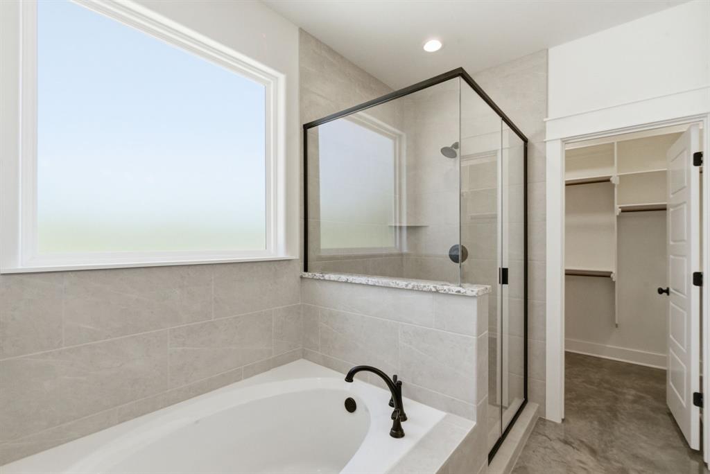 109 Graystone Weatherford, TX 76088 - Photo 14 of 26 a bathroom with a bathtub and a shower