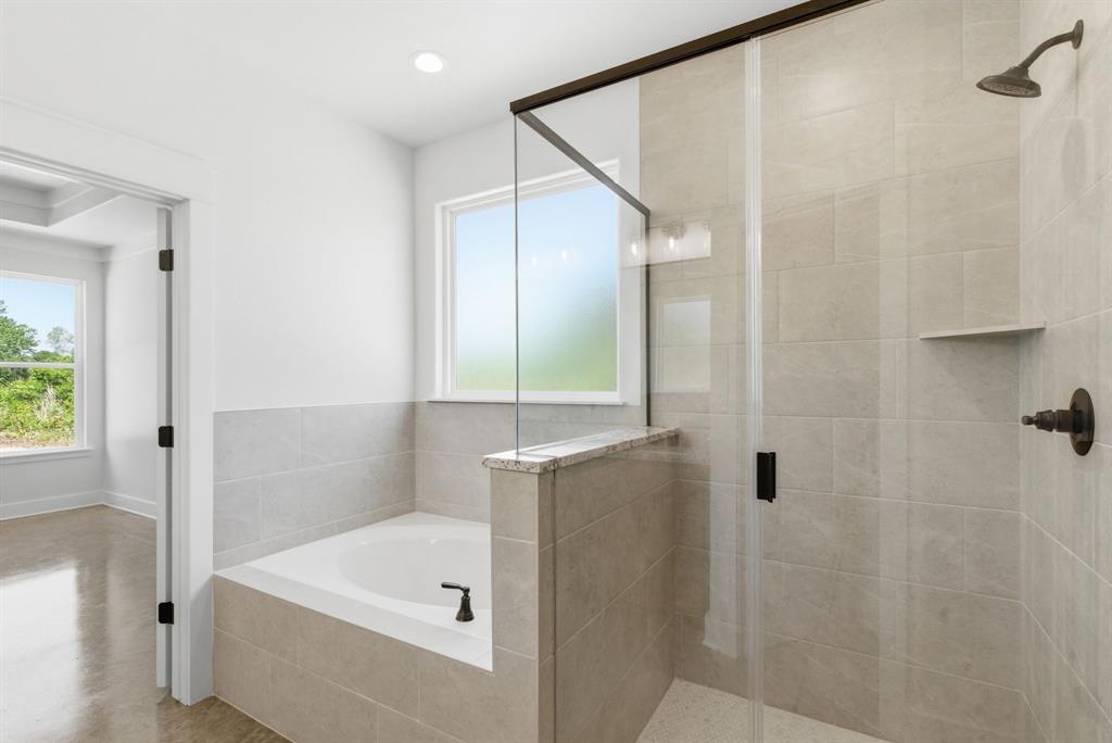 109 Graystone Weatherford, TX 76088 - Photo 15 of 26 a bathroom with a tub a sink and a shower