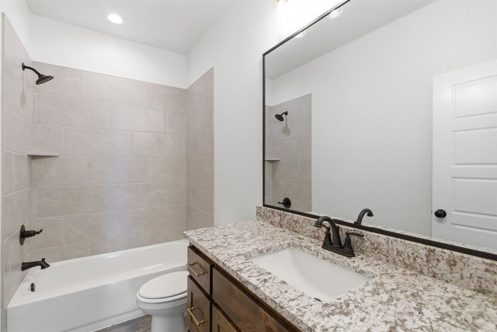 109 Graystone Weatherford, TX 76088 - Photo 18 of 26 a bathroom with a granite countertop sink toilet and shower