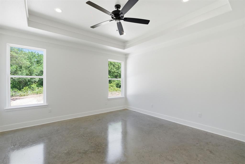 109 Graystone Weatherford, TX 76088 - Photo 20 of 26 an empty room with a window and a fan