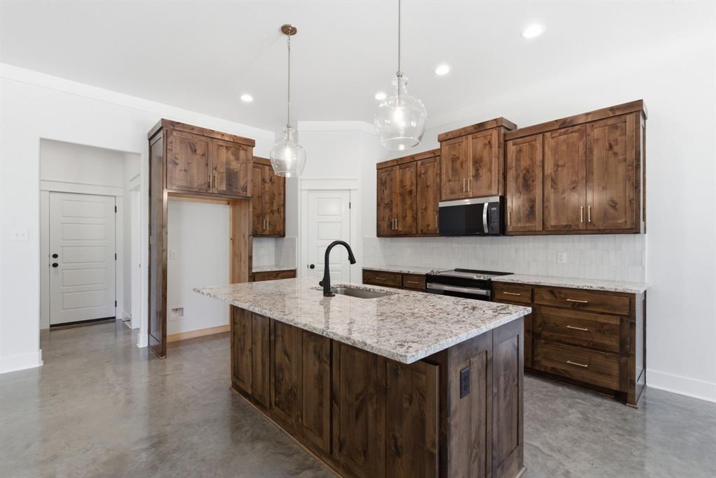 109 Graystone Weatherford, TX 76088 - Photo 4 of 26 a kitchen with a sink a counter space and cabinets