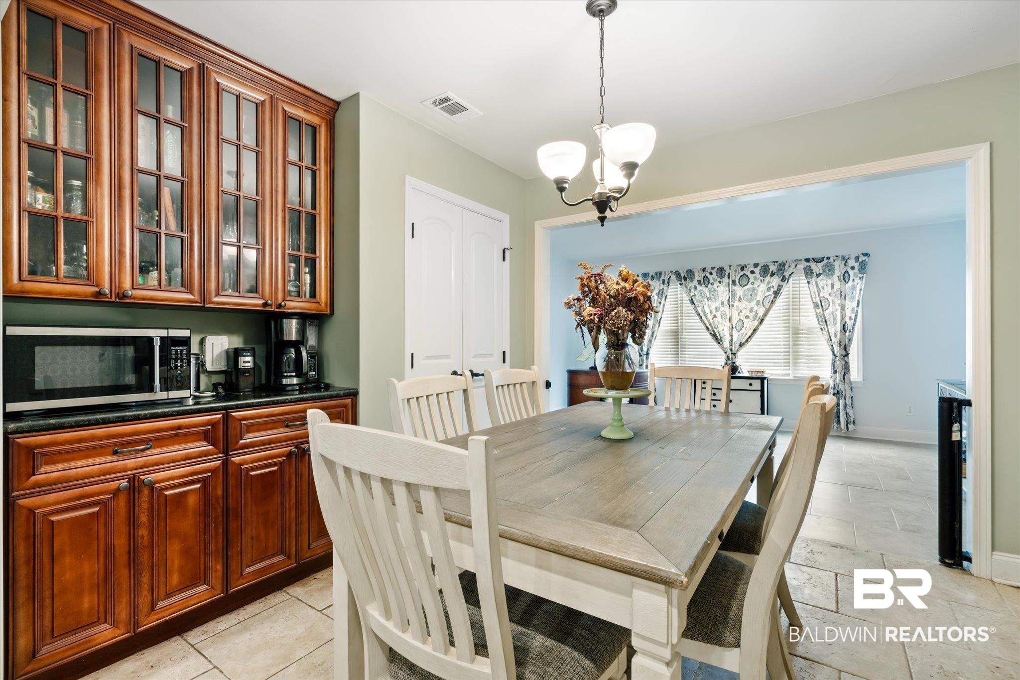 558 Stuart Street Daphne, AL 36526 - Photo 9 of 29 Tiled dining room featuring an inviting chandelier