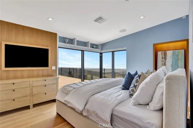 a bedroom with a large bed and a window