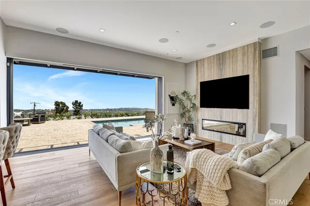 a living room with furniture and large windows