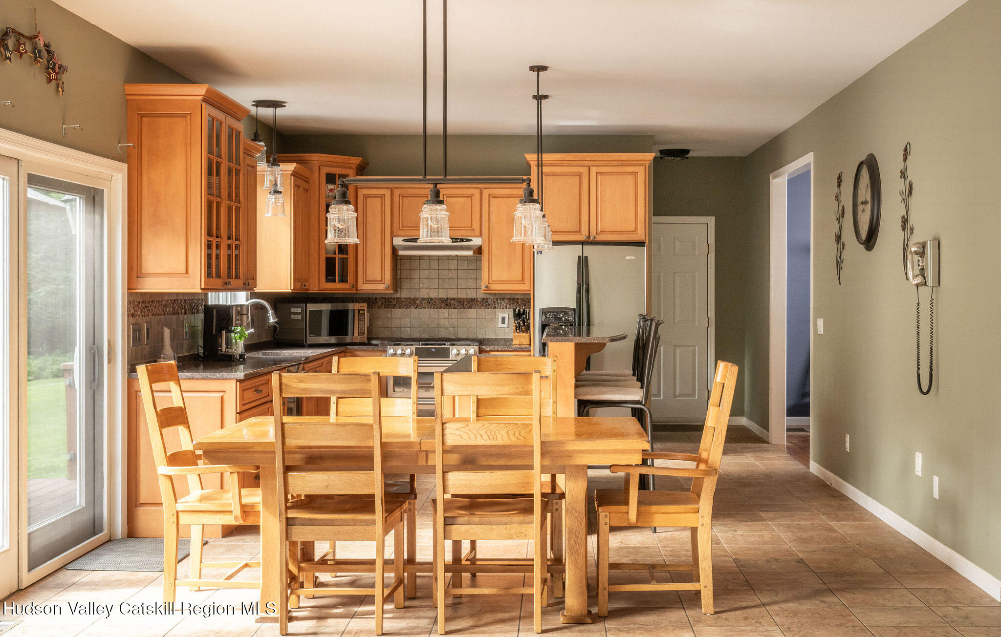 214 Wright Road Kerhonkson, NY 12446 - Photo 16 of 50 a kitchen with stainless steel appliances kitchen island granite countertop a table and chairs