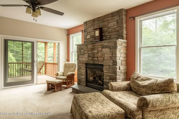 a living room with a fireplace and windows