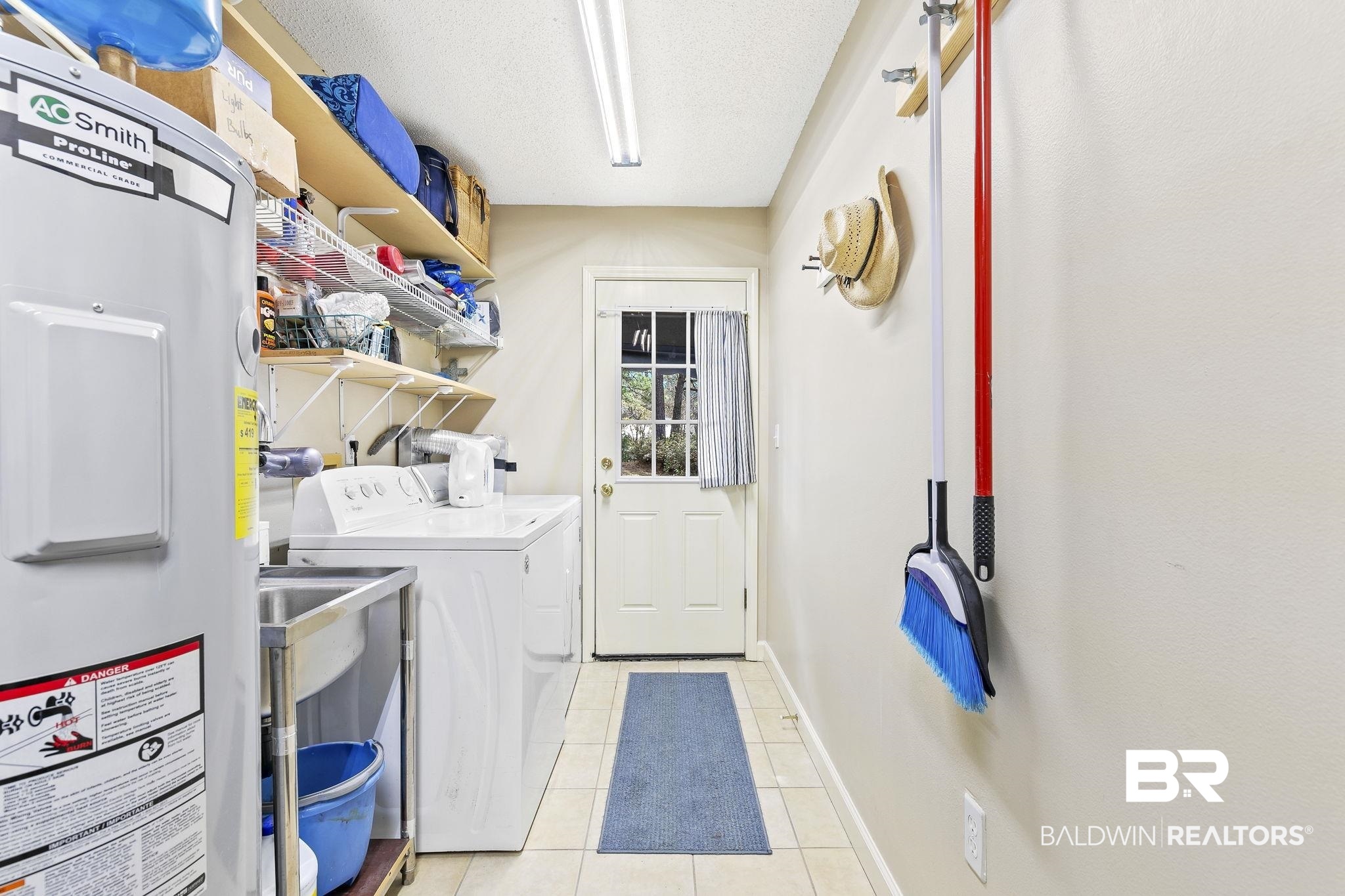 22 Pirates Lane Daphne, AL 36527 - Photo 20 of 36 Laundry area featuring washer and dryer, electric water heater, a textured ceiling, and light tile patterned floors