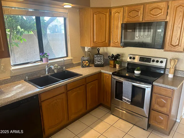 an empty room with a ceiling fan and window