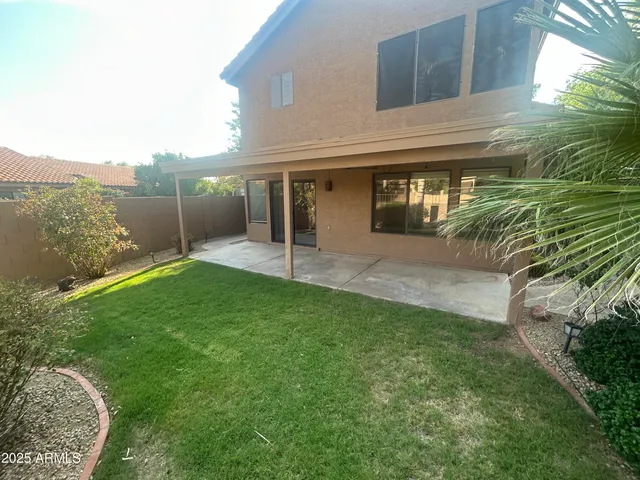 a swimming pool with outdoor seating and yard