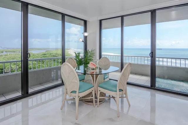a view of a dining room with furniture and a window