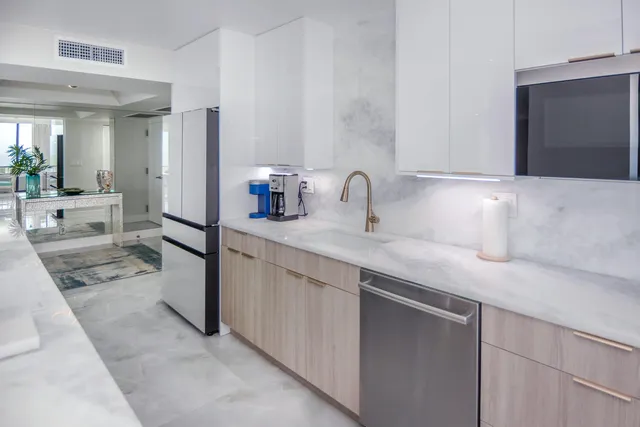 a bedroom with a bed a lamp and a dresser