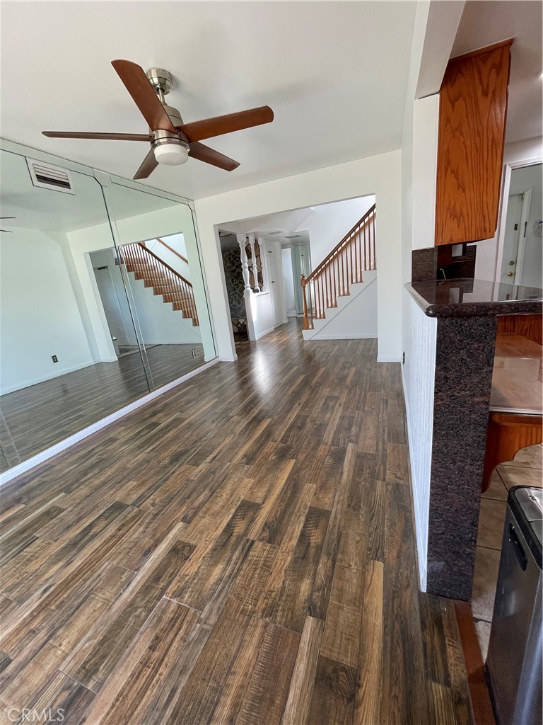 19426 Belshaw Avenue Carson, CA 90746 - Photo 11 of 19 a view of a livingroom with wooden floor and a ceiling fan