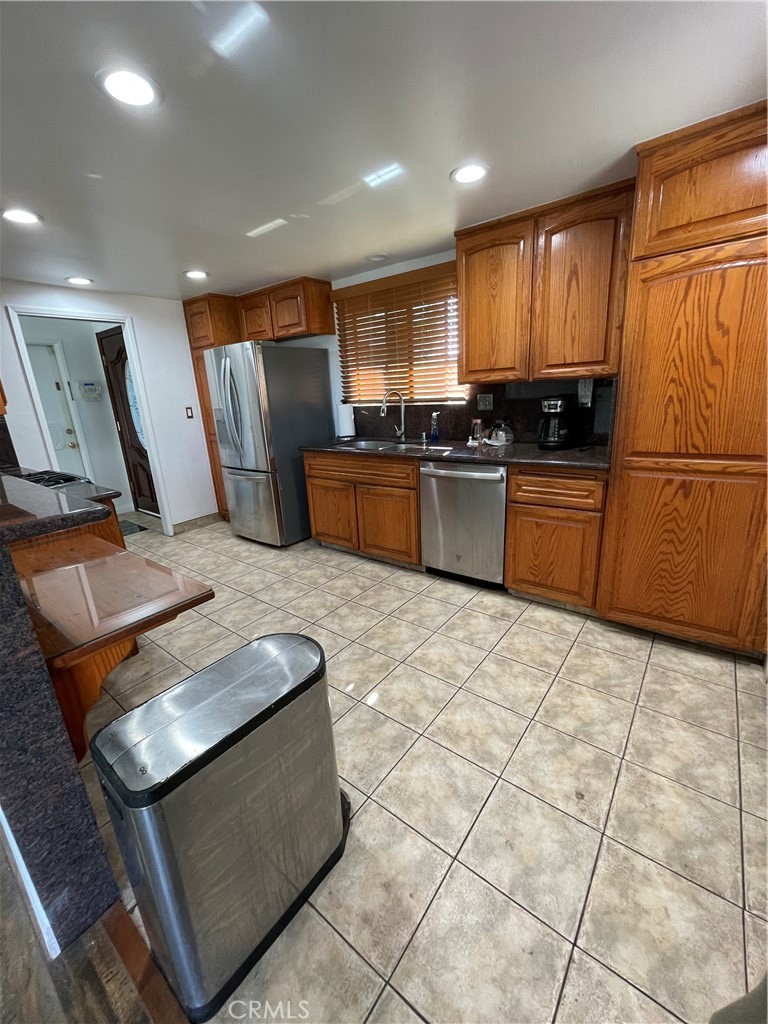 19426 Belshaw Avenue Carson, CA 90746 - Photo 5 of 19 a large kitchen with stainless steel appliances granite countertop a stove a sink and a refrigerator