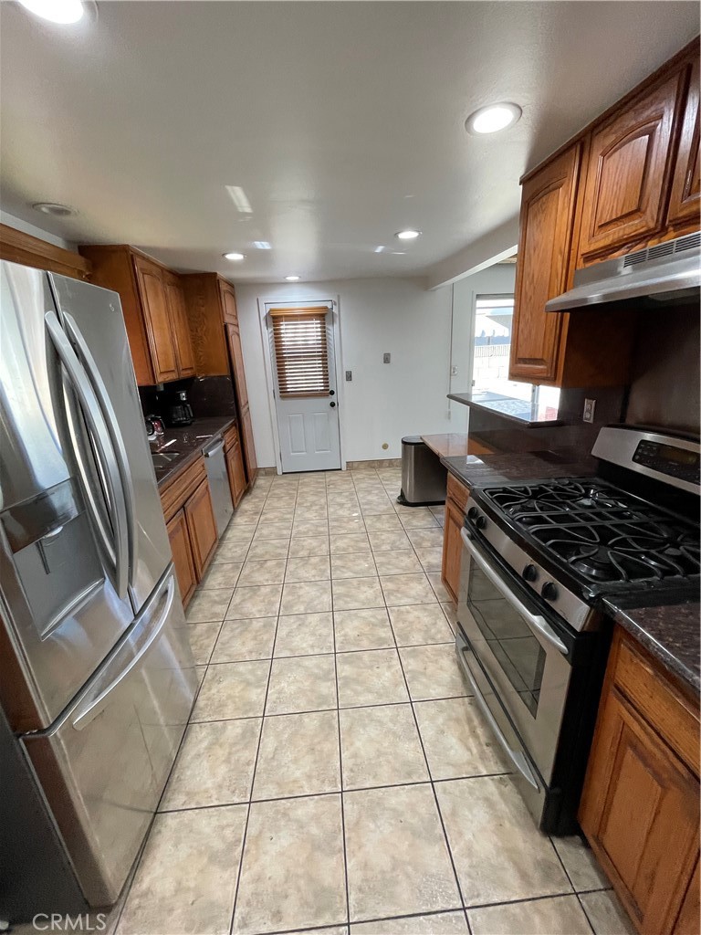 19426 Belshaw Avenue Carson, CA 90746 - Photo 6 of 19 a kitchen with stainless steel appliances granite countertop a stove and a sink