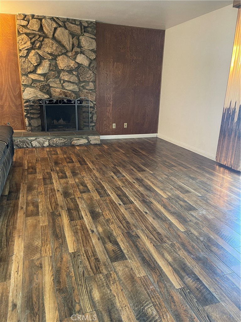 19426 Belshaw Avenue Carson, CA 90746 - Photo 8 of 19 a view of room with wooden floor and a fireplace