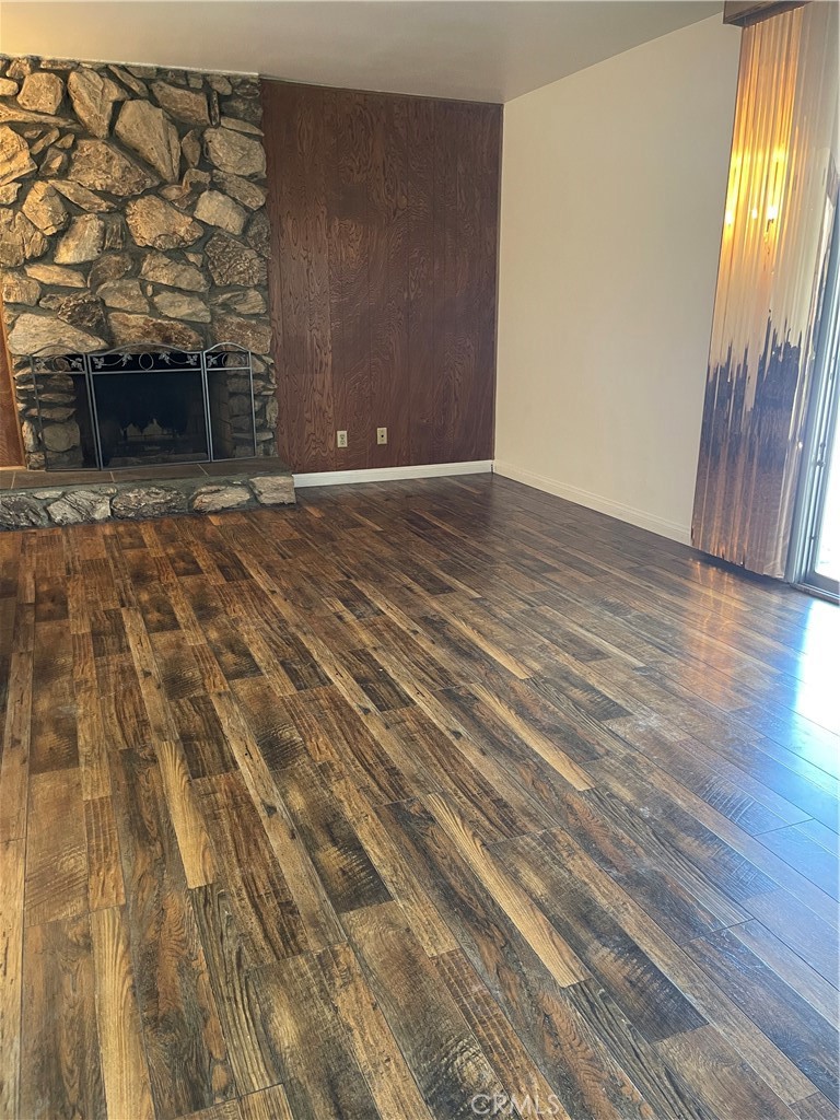 19426 Belshaw Avenue Carson, CA 90746 - Photo 10 of 19 a view of an empty room with wooden floor and a window