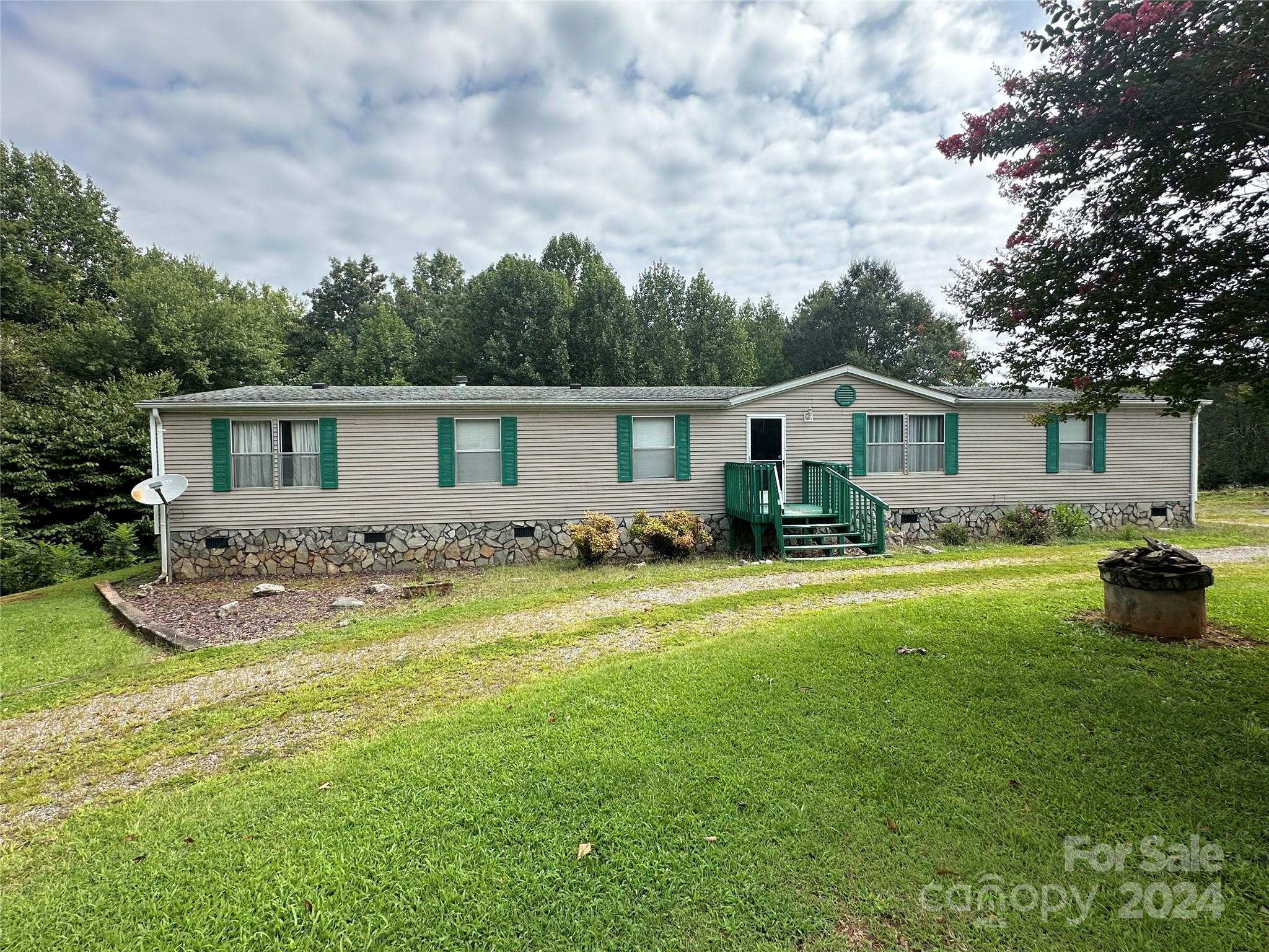 7014 Riverbend Road Claremont, NC 28610 - Photo 1 of 21 a front view of house with yard barbeque and outdoor seating
