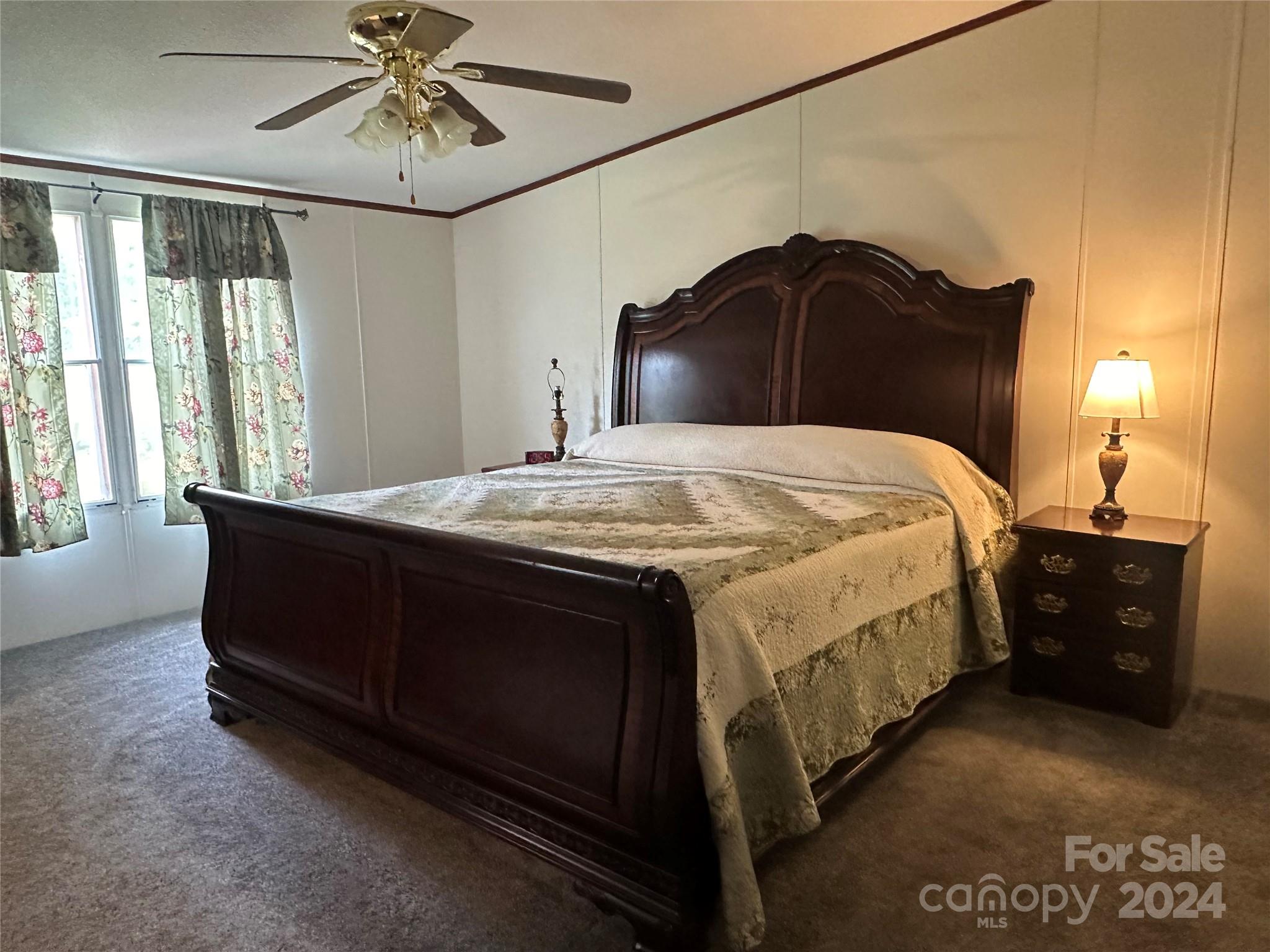 7014 Riverbend Road Claremont, NC 28610 - Photo 11 of 21 a bedroom with a bed and a chandelier