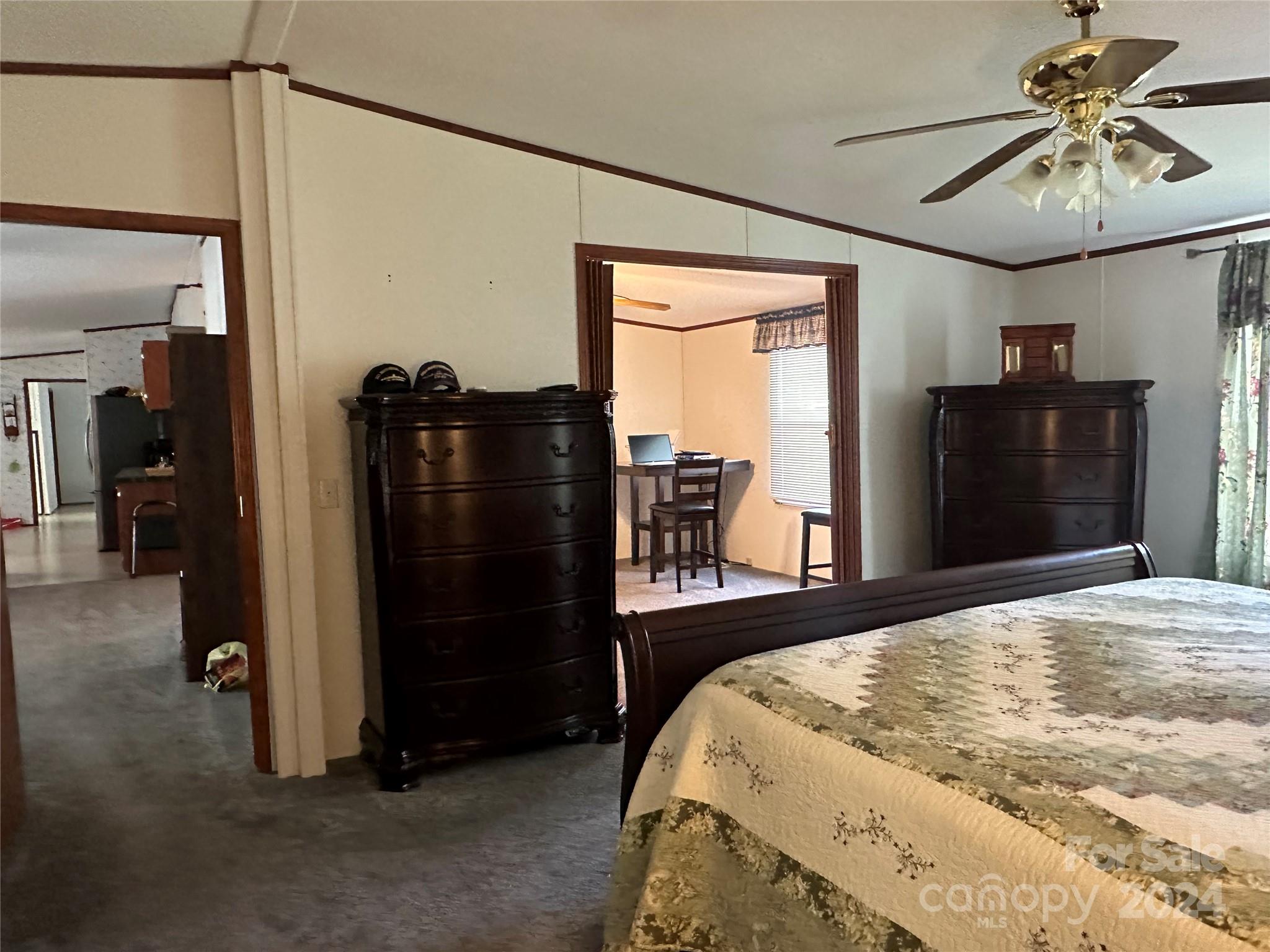 7014 Riverbend Road Claremont, NC 28610 - Photo 12 of 21 a bedroom with a bed and a chandelier