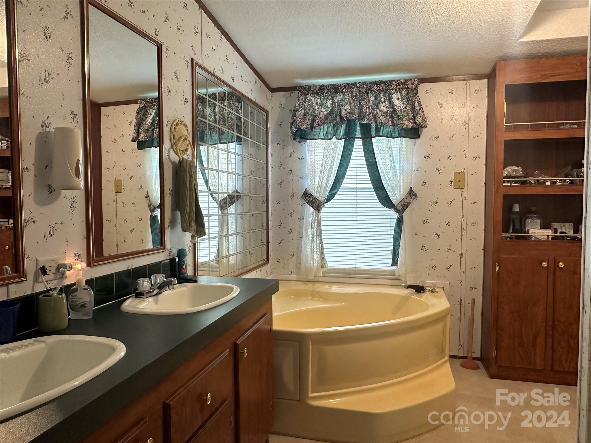 7014 Riverbend Road Claremont, NC 28610 - Photo 15 of 21 a bathroom with a granite countertop sink a bathtub and shower