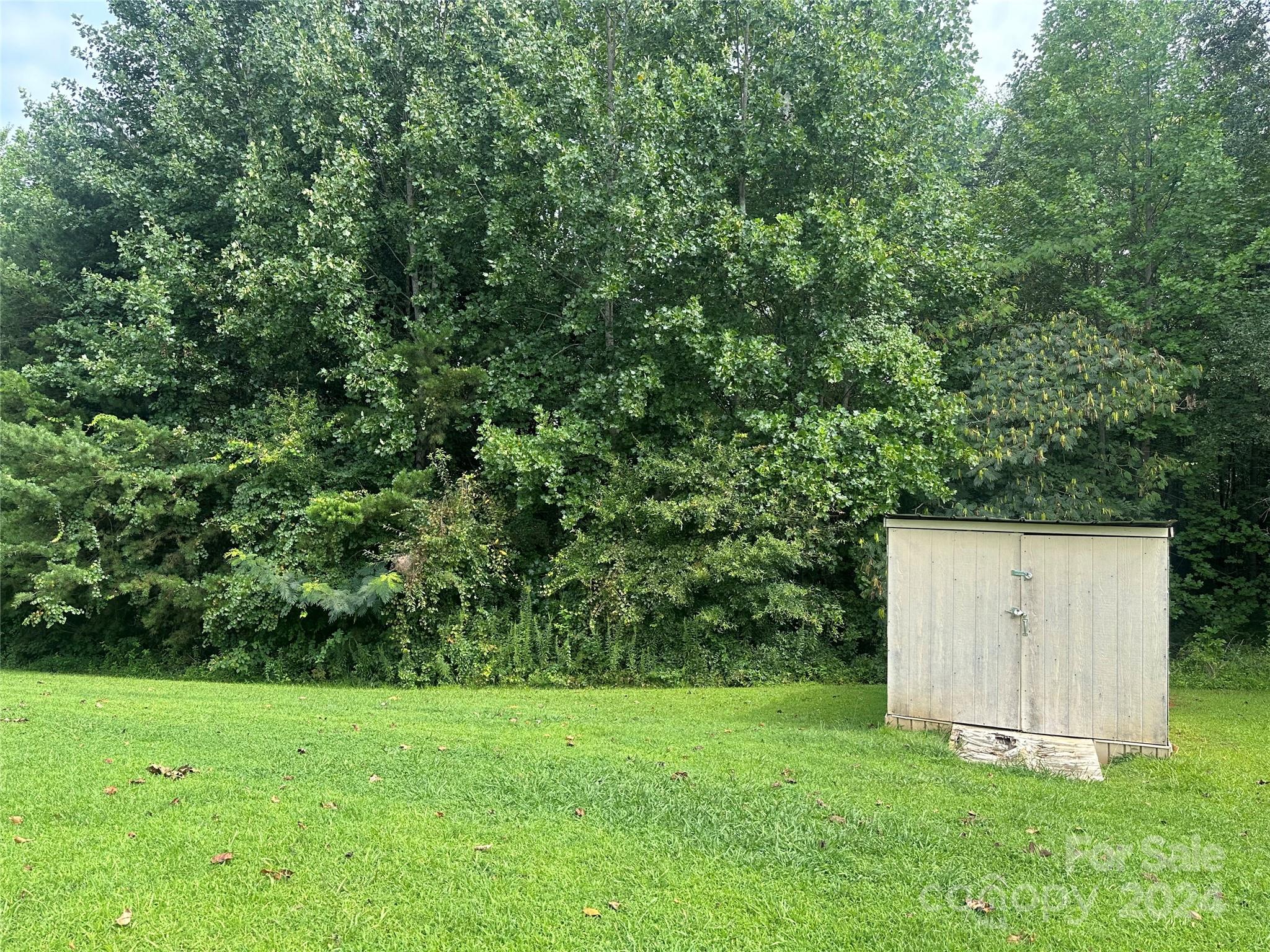 7014 Riverbend Road Claremont, NC 28610 - Photo 20 of 21 a view of a backyard with a garden