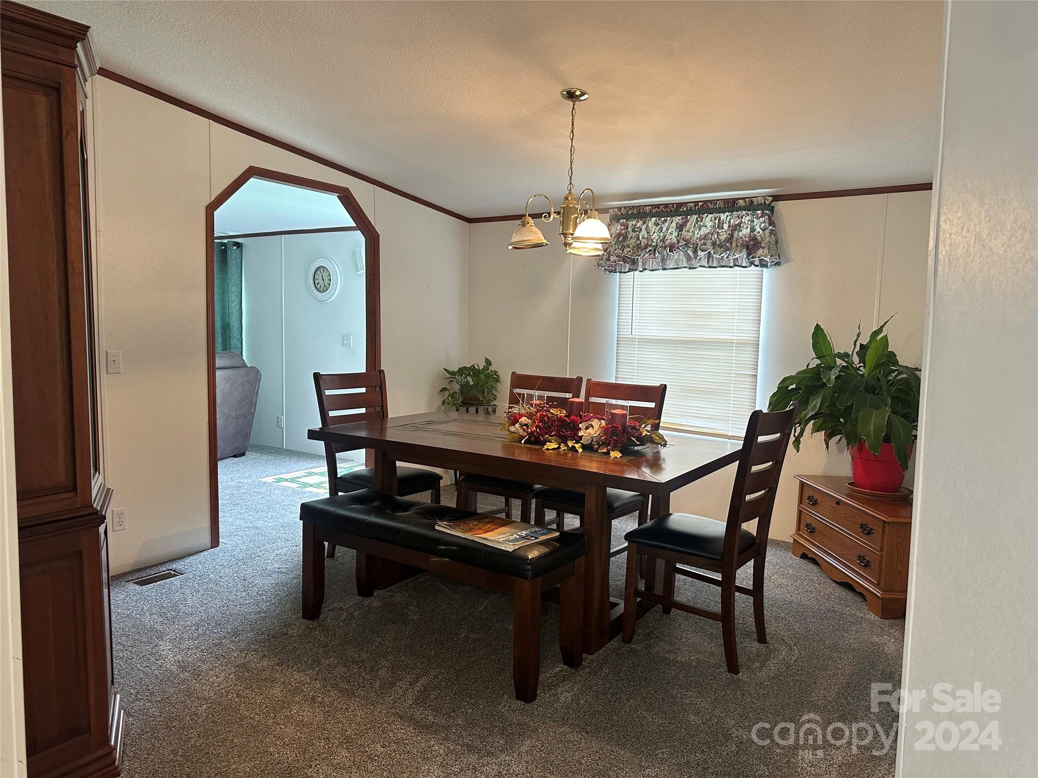 7014 Riverbend Road Claremont, NC 28610 - Photo 4 of 21 a living room with furniture and a chandelier