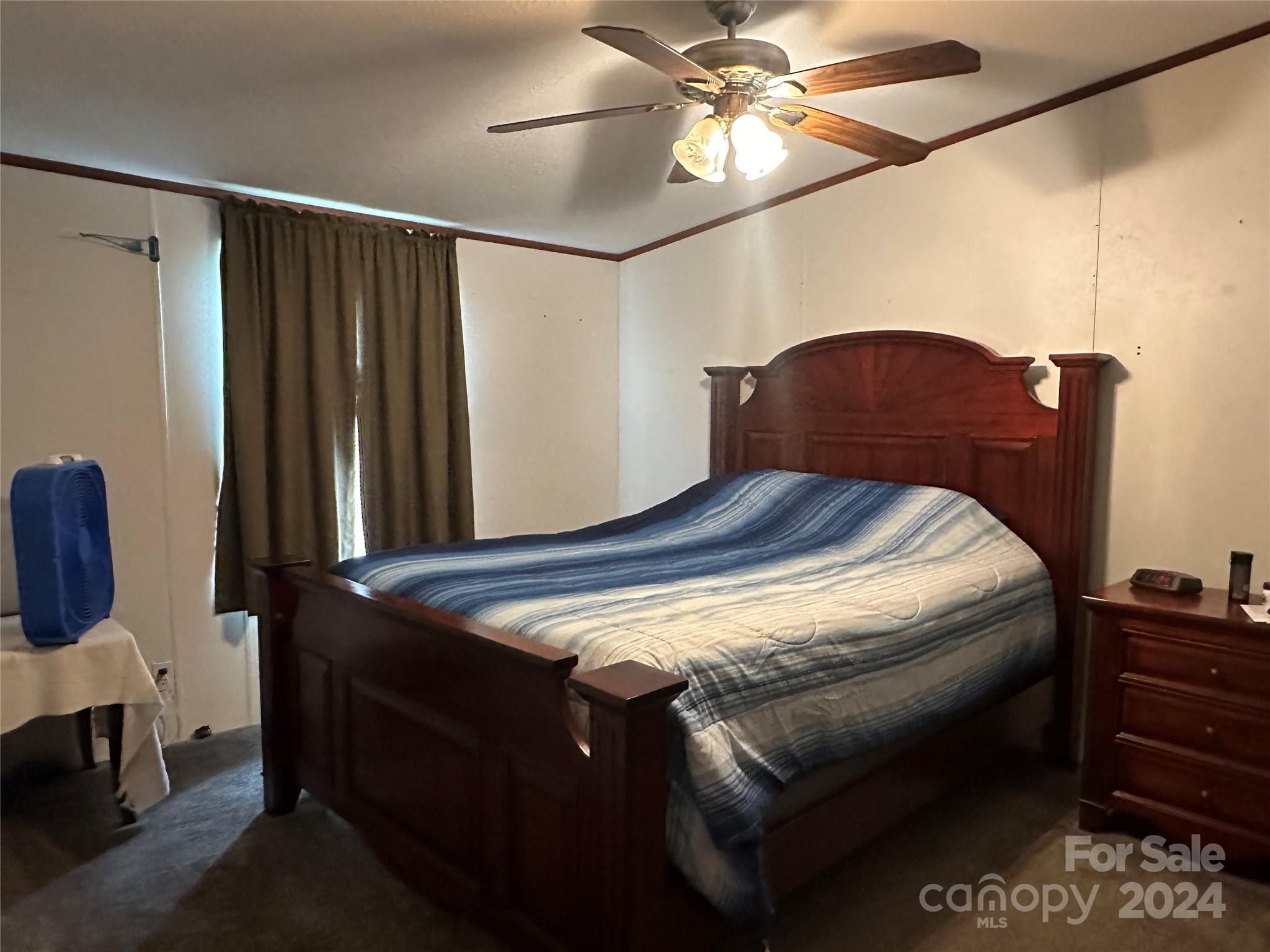 7014 Riverbend Road Claremont, NC 28610 - Photo 5 of 21 a bedroom with a bed and a chandelier