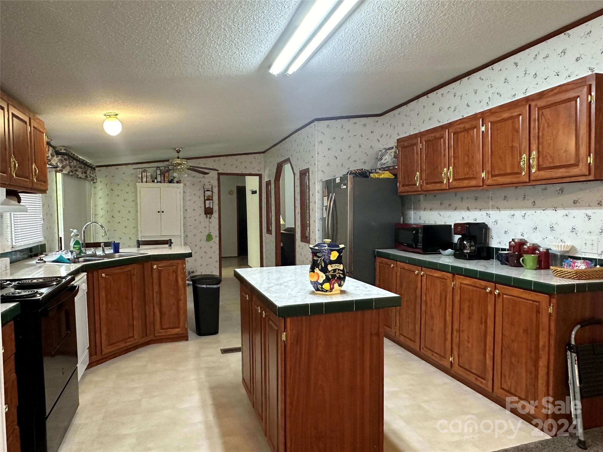 7014 Riverbend Road Claremont, NC 28610 - Photo 6 of 21 a kitchen with stainless steel appliances granite countertop a sink stove and refrigerator