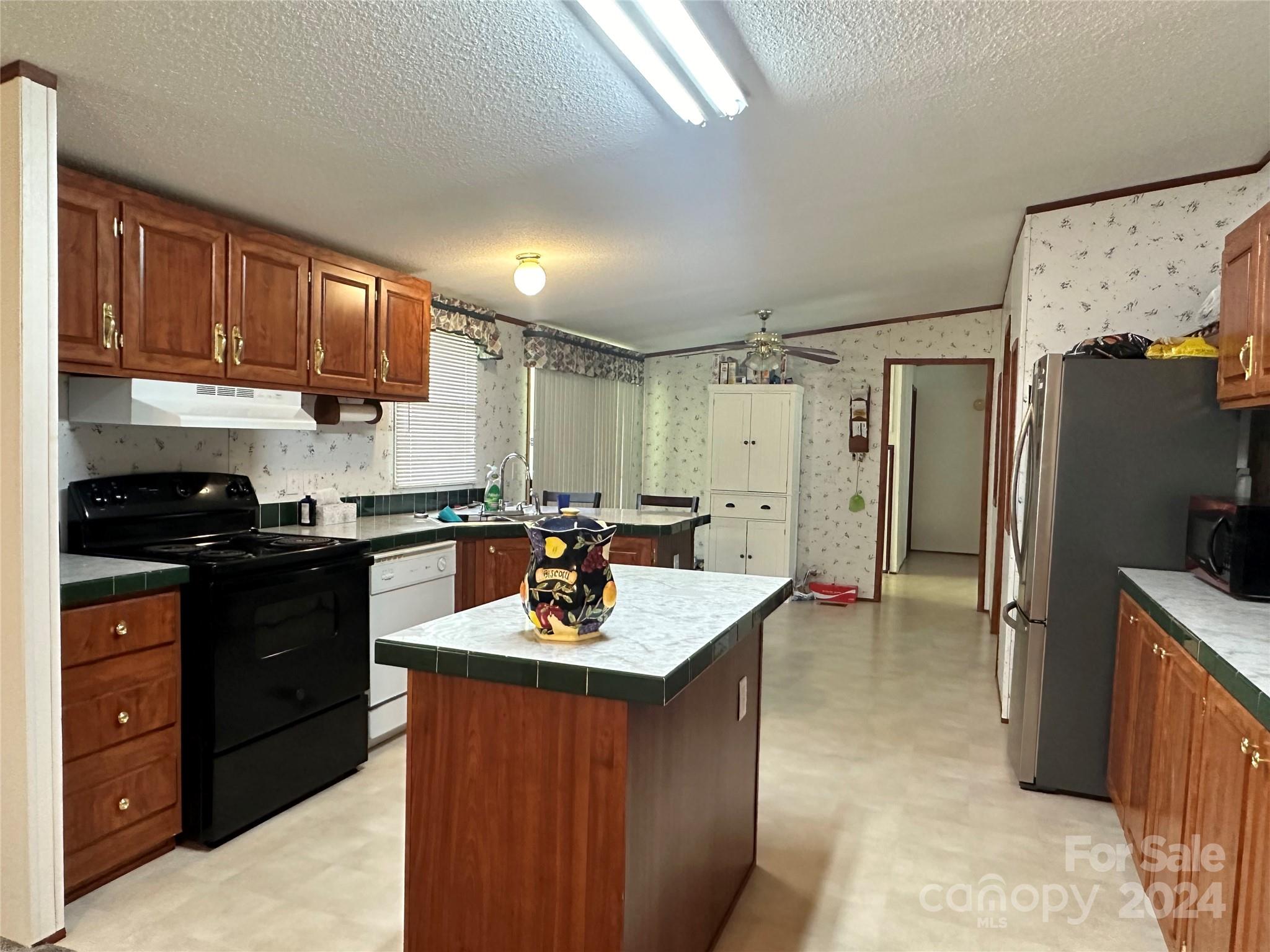 7014 Riverbend Road Claremont, NC 28610 - Photo 7 of 21 a kitchen with a sink refrigerator and cabinets