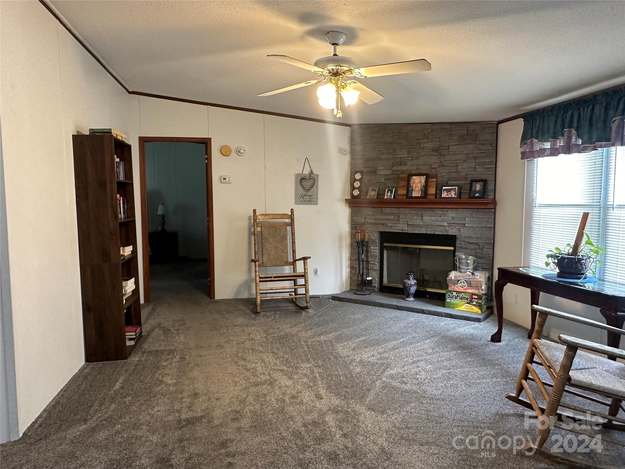 7014 Riverbend Road Claremont, NC 28610 - Photo 8 of 21 a view of a livingroom with a fireplace and a window