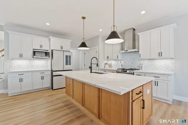 a white refrigerator freezer sitting inside of a kitchen