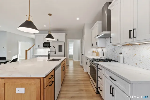 a bathroom with a granite countertop toilet sink and mirror