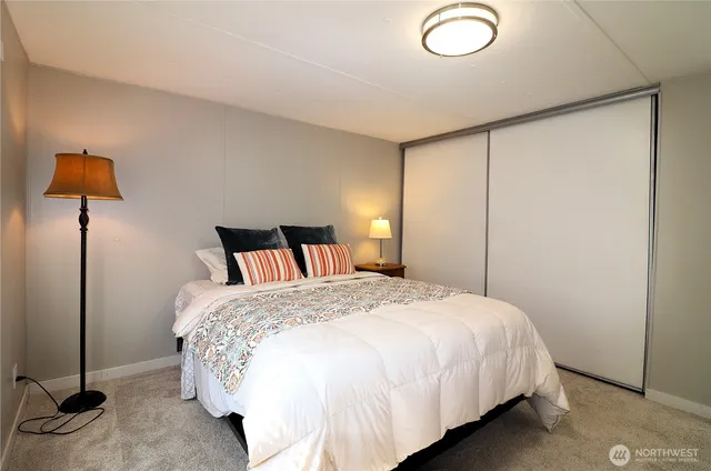 a bedroom with a bed and a lamp