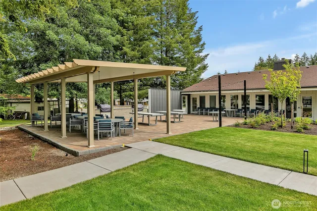 a view of a patio with a table and chairs under an umbrella