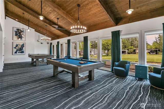 a living room with furniture a table and wooden floor