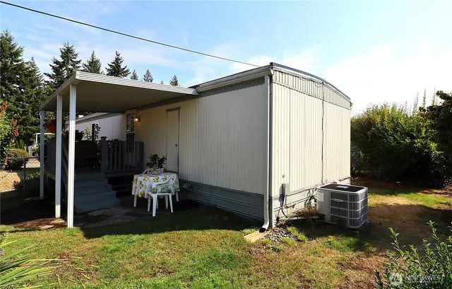 a backyard of a house with yard fire pit and outdoor seating