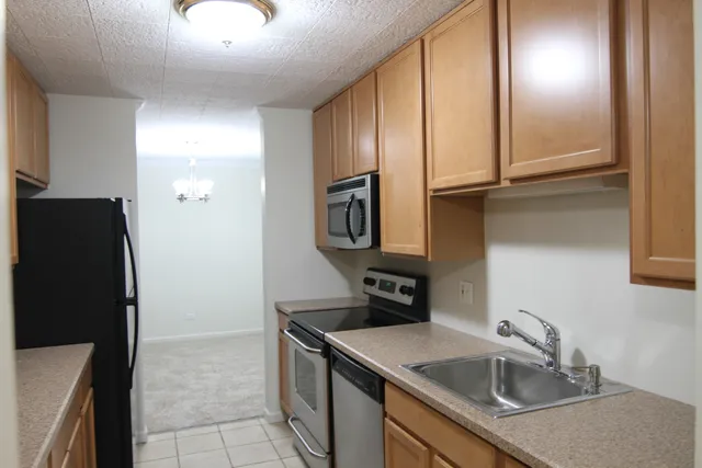a kitchen with a sink and a refrigerator