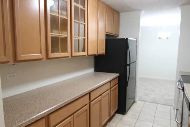 a kitchen with stainless steel appliances granite countertop a sink refrigerator and microwave