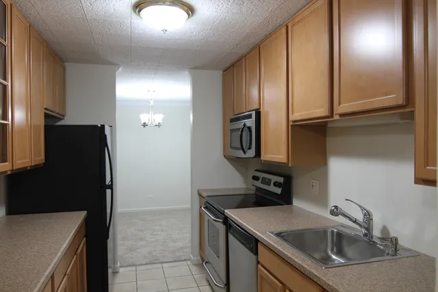 a kitchen with a refrigerator and cabinets