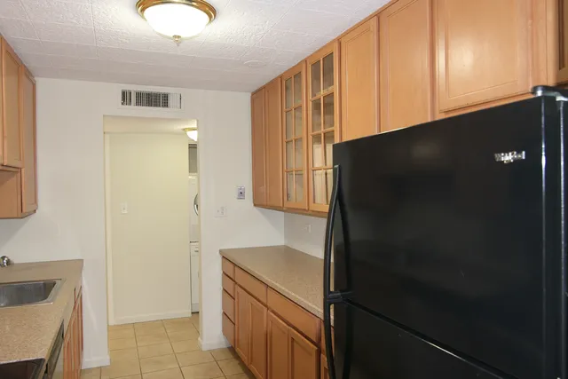 a kitchen with a refrigerator and a sink