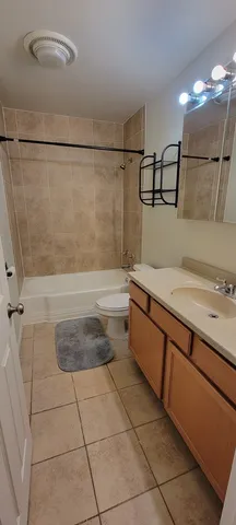 an empty room with chandelier fan