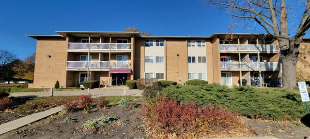 a front view of a building with a garden