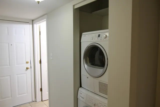 a view of a house with a window and wooden fence