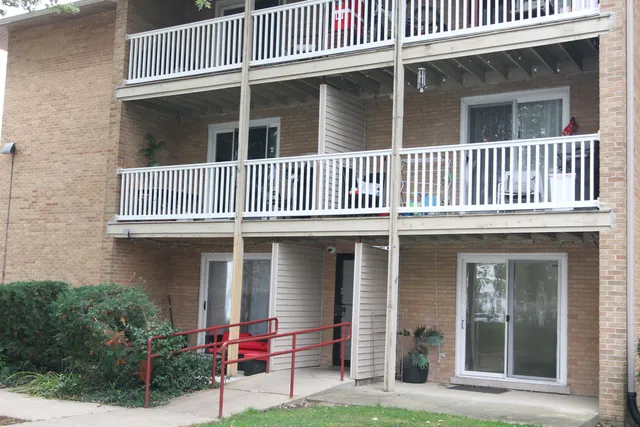 a backyard of a house with potted plants