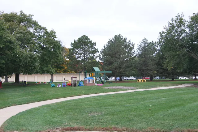 a view of a park with swings and slides