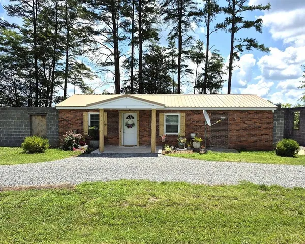 a front view of a house with a yard and porch